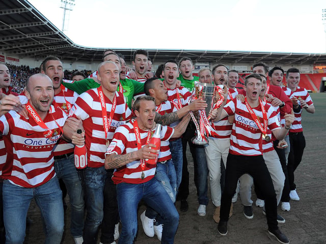 The Rovers squad celebrate promotion and the League One title
