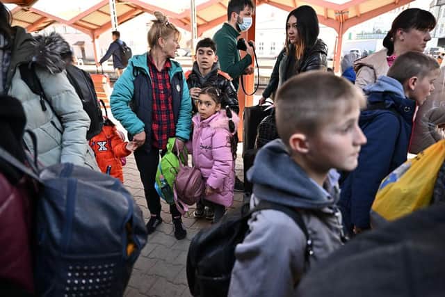 PREZEMYSL, POLAND - MARCH 23: People, mainly women and children, board a train at Przemysl station as they continue their onward journey from in war-torn Ukraine on March 23, 2022 in Przemysl, Poland. Nearly two-thirds of the more than 3.5 million people to have fled Ukraine since Russia's invasion last month have come to Poland, which shares a 310-mile border with its eastern neighbor. (Photo by Jeff J Mitchell/Getty Images)
