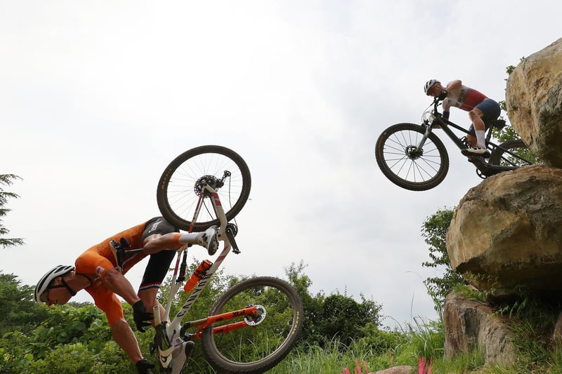 (L-R) Mathieu van der Poel of Team Netherlands suffers a fall ahead of Thomas Pidcock of Team Great Britain during the Men's Cross-country race