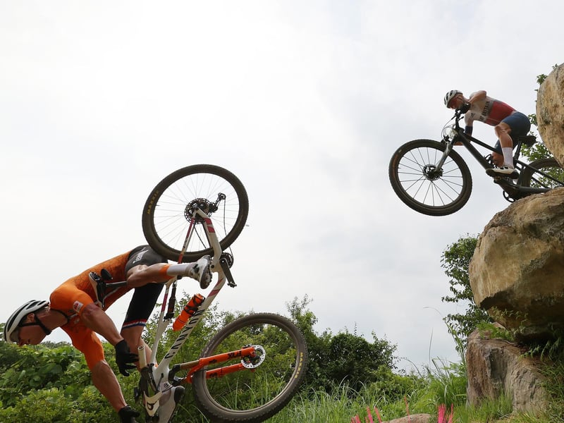 (L-R) Mathieu van der Poel of Team Netherlands suffers a fall ahead of Thomas Pidcock of Team Great Britain during the Men's Cross-country race