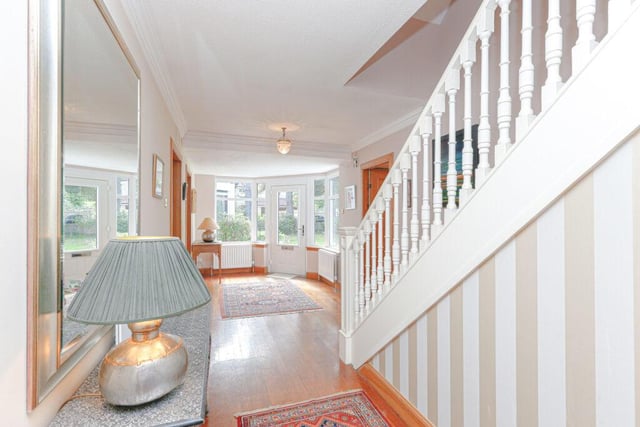 The welcoming and spacious entrance hall has wood flooring, radiator and carpeted staircase to upper floor.