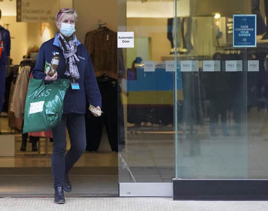 A woman keeping her mask on as she leaves Marks and Spencer store in the city centre.