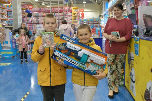 These youngsters were happy to be back in the toy shop.