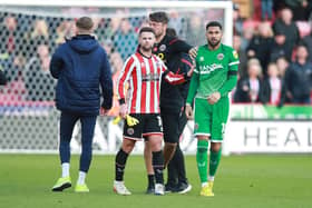 Wes Foderingham of Sheffield United (r) after being sent off against Blackpool: Lexy Ilsley / Sportimage