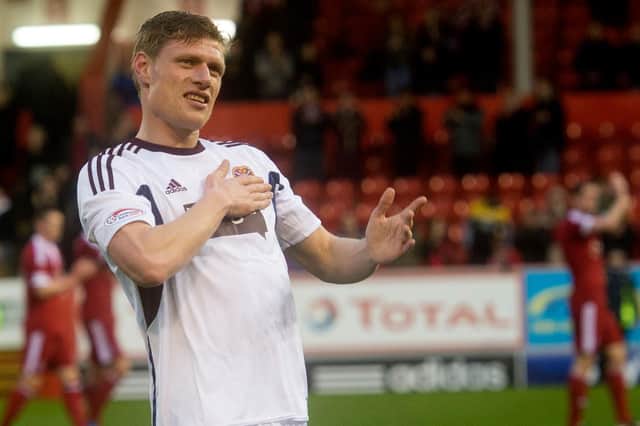 Marius Zaliukas salutes the fans at full-time after making his final appearance for the club