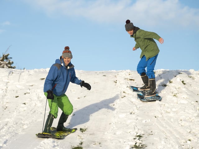 Brothers Gordon and Alex Aitken turn their sledges into snowboards at The Braids