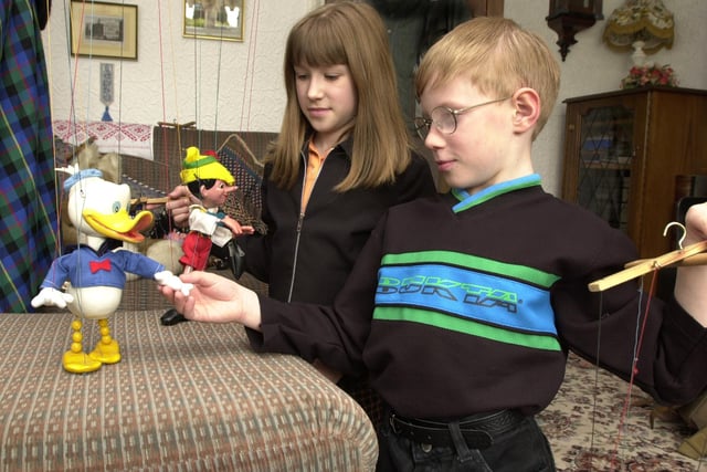 Vikki Bonser, 9 and Alex Bonser, 7 play with puppets at their grandmother's house in 2000