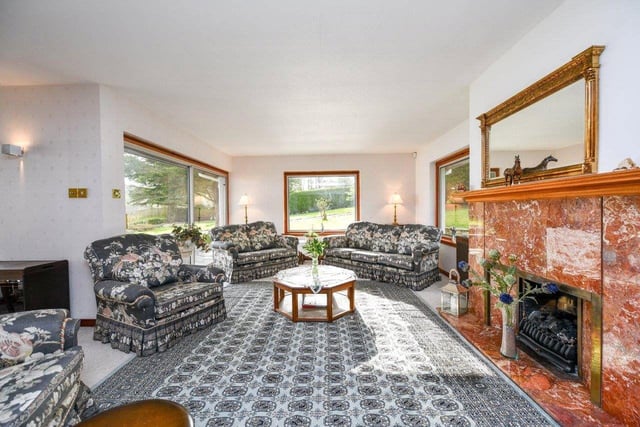The living room is bright and spacious, and has a feature fireplace.