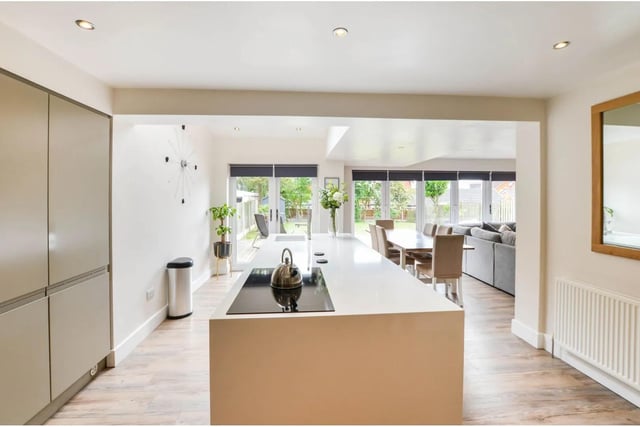 There are a comprehensive range of high gloss wall and base units with integrated appliances including dish washer, fridge freezer, single oven and microwave. The kitchen area has vinyl flooring and spot lights to the ceiling.