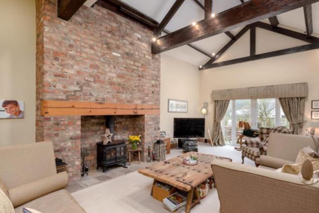 Exposed woodbeams feature in the property's impressive living room.