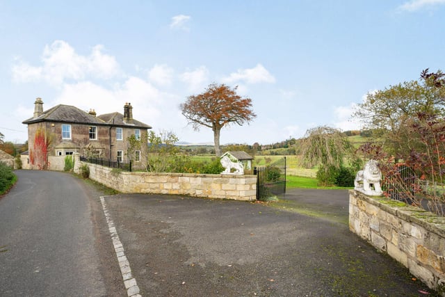 A low stone wall fronts the lane with two pedestrian gates and two vehicular entrances, one which leads onto a driveway providing parking for numerous cars and giving access to the outbuildings.