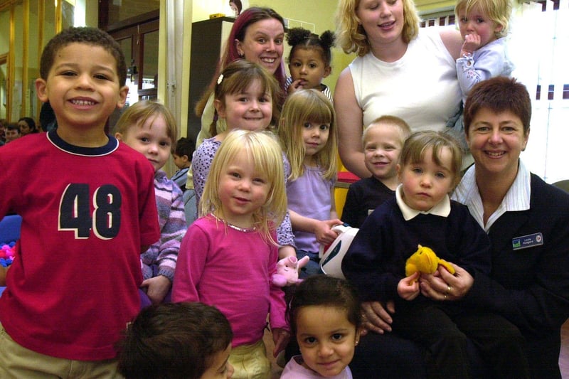 Lloyds  TSB Meadowhall branch manager Linda Rodgers (seated right) with some of the mums and children from the  Flower Estate Community Association Playgroup pictured in 1999