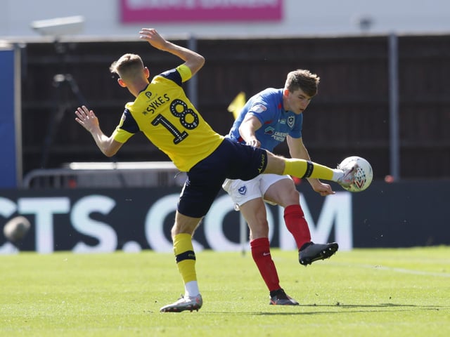 Mark Sykes of Oxford United and Pompey's Steve Seddon in action.