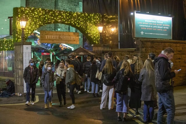 Drinkers queue outside The Three Sisters on Cowgate on Thursday night.