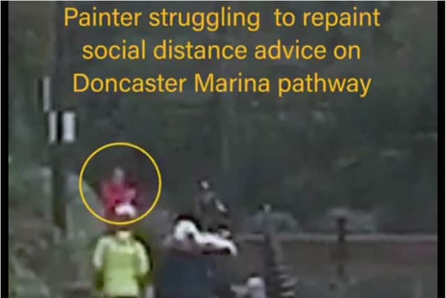 The clip of a worker struggling to paint a sign at Doncaster Lakeside.