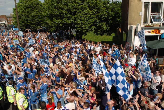 Fans cheer and clap the players on the Pompey bus, as it approaches Southsea Common. Picture: Malcolm Wells 082235-81