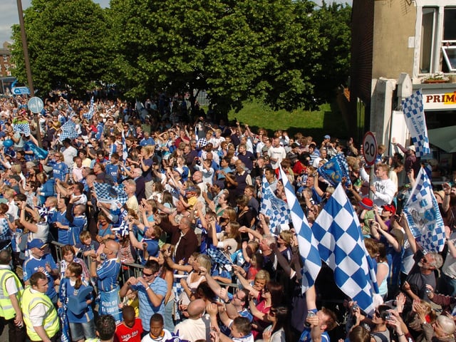 Fans cheer and clap the players on the Pompey bus, as it approaches Southsea Common. Picture: Malcolm Wells 082235-81