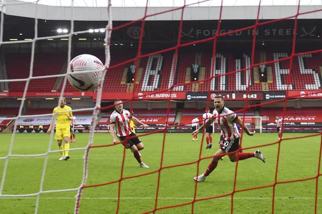 Sheffield United's Billy Sharp, right, celebrates after scoring his side's opening goal from the penalty spot during the Premier League match between Sheffield United and Fulham at Bramall Lane (Gareth Copley/Pool via AP)