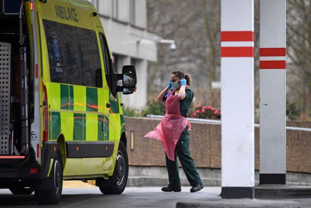 A member of NHS staff wearing PPE of gloves, an apron and a face mask as a preactionary measure against COVID-19. (Photo by DANIEL LEAL-OLIVAS / AFP) (Photo by DANIEL LEAL-OLIVAS/AFP via Getty Images)