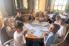Rockingham Junior School pupils working on designs for artist Bruce Asbestos