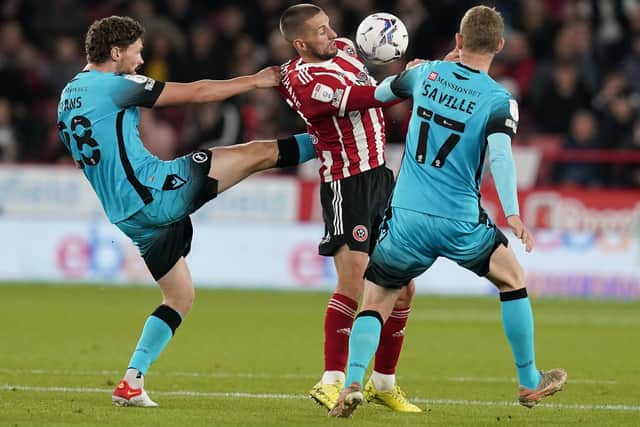 Conor Hourihane of Sheffield United vies with George Evans and George Saville of Millwall during the Sky Bet Championship match at Bramall Lane, Sheffield. Photo: Andrew Yates / Sportimage