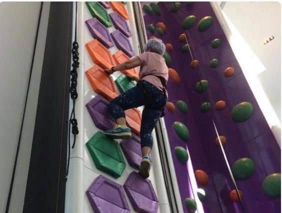 Pam Rawson, described by her daughter as 'fearless', is seen here taking on a climbing wall in her late 70s