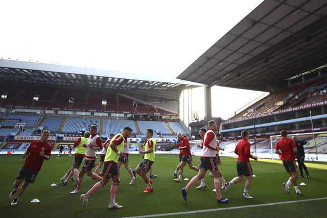 Sheffield United's players warm up before the English Premier League soccer match between Aston Villa and Sheffield United at the Villa Park stadium in Birmingham, Monday, Sept. 21, 2020. (Tim Goode/Pool via AP)