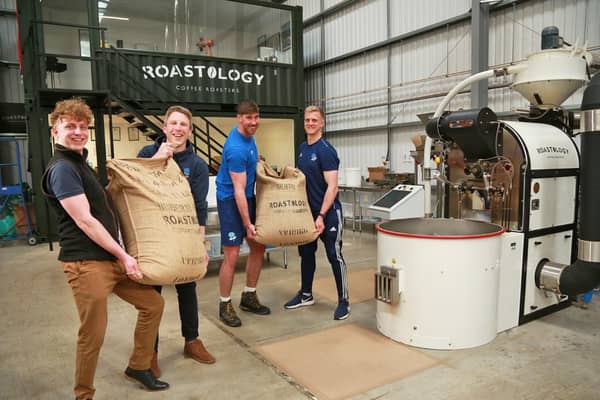 Cafeology's sustainability manager Liam Worsley, left, unloads the coffee he helped pick in Costa Rica with members of Sheffield RUFC, one of Cafeology's local customers