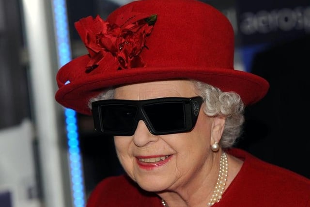 HM The Queen wears 3D glasses to watch a display and pilot a JCB digger during a visit to the University of Sheffield Advanced Manufacturing Research Centre.