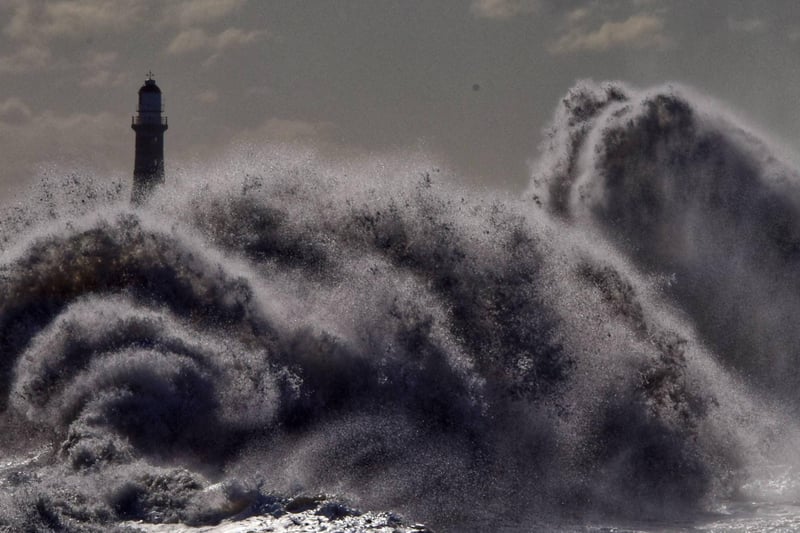 Roker Pier is submerged by the waves.