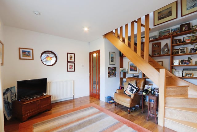 The sitting room is located at the front of the property. The staircase goes upstairs to what is currently a study.