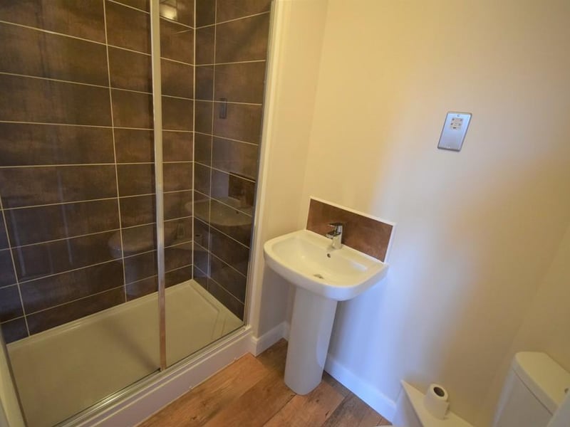 A high quality finish ensuite having new electric shower, cubicle and screen with contrasting wall tiles, wc, wash hand basin with chrome mixer tap, stainless steel shaver point, wall mounted towel rail and extractor fan.