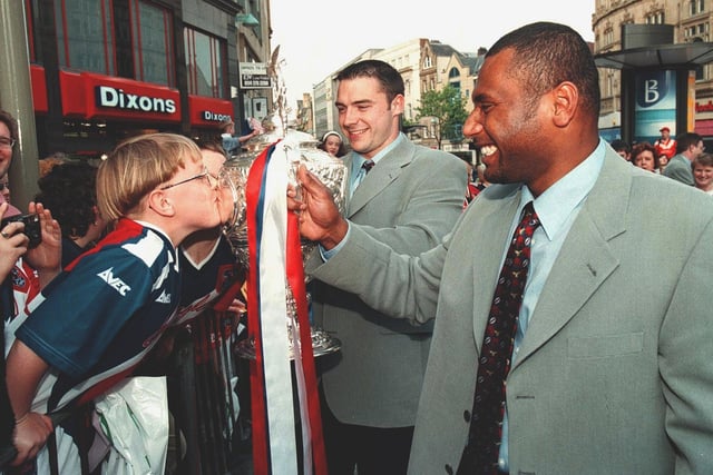 A young Sheffield Eagles fan kisses the Challenge Cup as the team parade along Fargate, Sheffield, on their way to a Civic Reception at the Town Hall in 1998