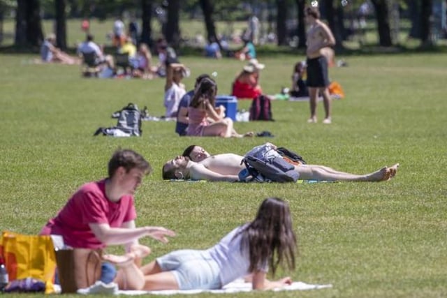 People sunbathe and exercise in the good weather in The Meadows. Photo: Jane Barlow/PA Wire