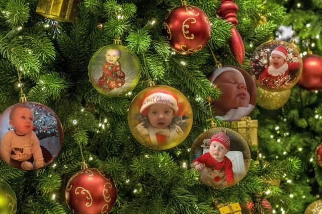 More adorable photos of children celebrating their first Christmas.