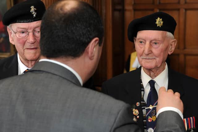 French Honorary Consul M.Jean-Claude La Fontaine presents a medal to Cyril Elliot at a medal ceremony presenting Normandy Veterans with the Legion of Honour. Picture: Andrew Roe