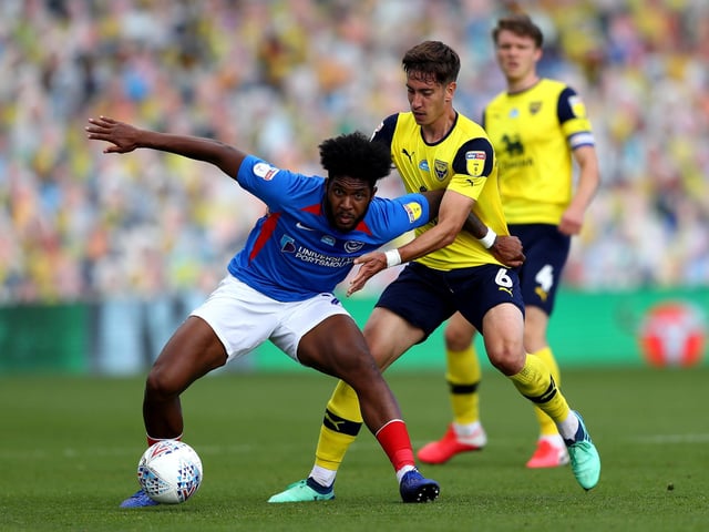 Ellis Harrison holds off Alex Gorrin of Oxford United.