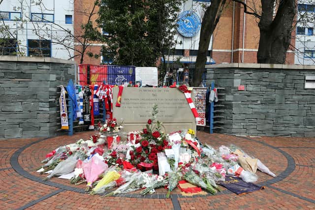 Flowers, scarves and shirts are laid at the memorial site at Hillsborough stadium on the 25th anniversary of the disaster that killed 96 people.