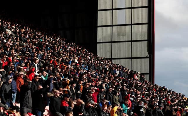 BARNSLEY, ENGLAND - OCTOBER 24: Sheffield United fans shade themselves from the sun during the Sky Bet Championship match between Barnsley and Sheffield United at Oakwell Stadium on October 24, 2021 in Barnsley, England. (Photo by George Wood/Getty Images)
