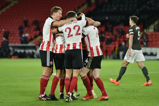 SHEFFIELD, ENGLAND - DECEMBER 17: David McGoldrick of Sheffield United celebrates with team mates after scoring their sides first goal during the Premier League match between Sheffield United and Manchester United at Bramall Lane on December 17, 2020 in Sheffield, England. The match will be played without fans, behind closed doors as a Covid-19 precaution.  (Photo by Peter Powell - Pool/Getty Images)