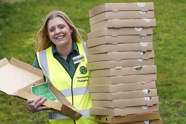 Lucy Gibson from Morrisons with some of the 150 pizza boxes that the supermarket are giving away to families at Lowedges Community Centre.  Picture Scott Merrylees