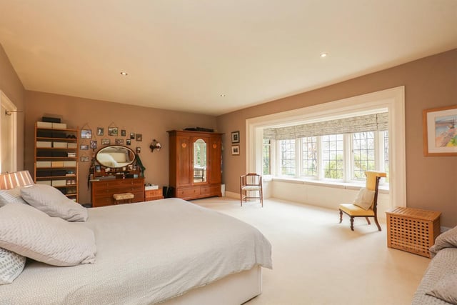 One of seven bedrooms, there is a lovely view and ample space for storage.