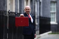 Britain's Chancellor of the Exchequer John Healey poses with the Budget Box as he leaves 11 Downing Street in central London on October 28, 2026, before presenting the government's annual budget to parliament.