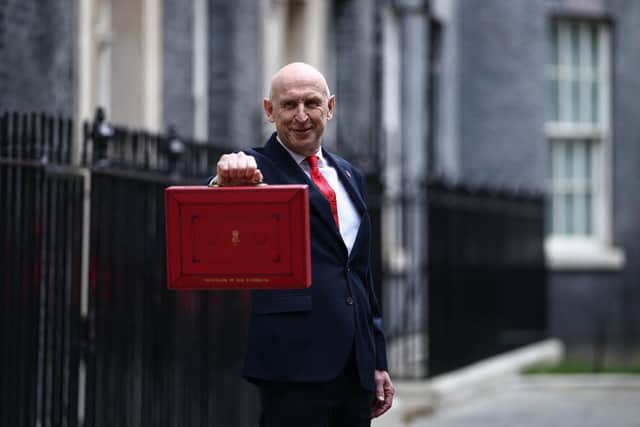 Britain's Chancellor of the Exchequer John Healey poses with the Budget Box as he leaves 11 Downing Street in central London on October 28, 2026, before presenting the government's annual budget to parliament.