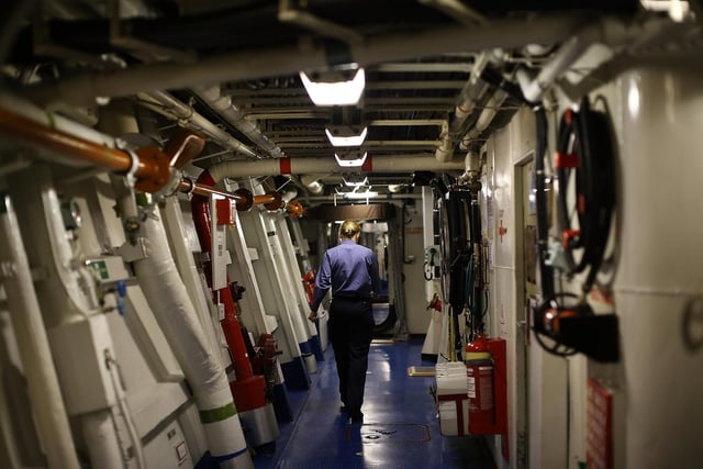 A female sailor seen walking through a corridor on HMS Illustrious back in May 10, 2013. Photo by Dan Kitwood/Getty Images