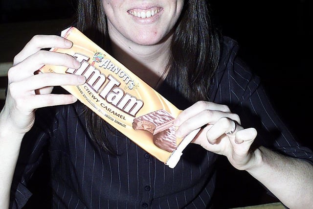 Walkabout assistant manager Kelly Harding (from New Zealand) with a packet of Tim Tams as part of their Australia Day challenge