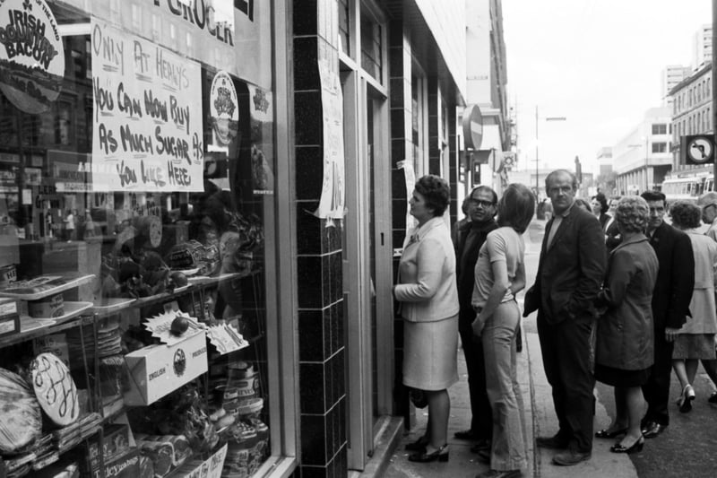 Glasgow shoppers queue at an Argyle Street  grocers for sugar, available after the shortage of August 1974.