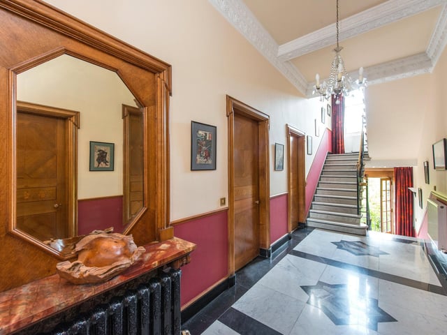 The house covers three floors, with wide staircases and Italian marble floors