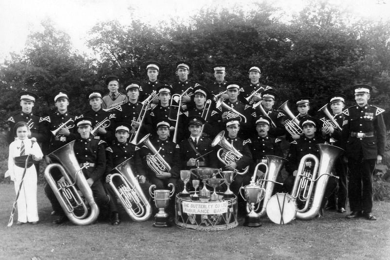 The Butterley Company Ambulance Band with trophies at Codnor Miners Welfare in 1938. Does anyone know who the child is?