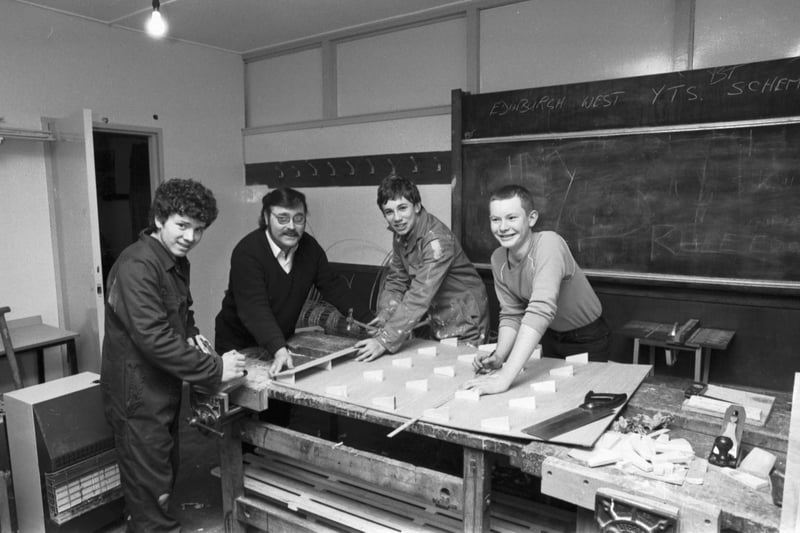 Teenage boys on the Youth Opportunities Programme (YOP) employment scheme help to decorate the Clermiston pavilion in Edinburgh, March 1984.